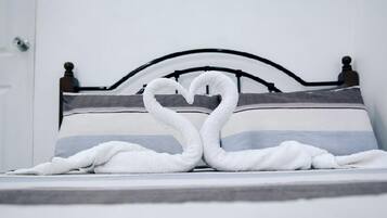 A bed with a headboard and a pillow.
