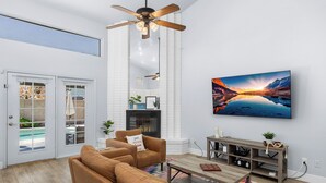 Una sala de estar moderna con sofá, mesa de centro y chimenea.