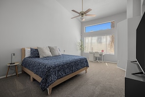 A bedroom with a bed, a desk, a chair, a ceiling fan, and a window with blinds. - Spacious Retreat w/ Free Heated Pool – Close to Stadium & Ballparks! (Peoria)