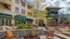 A building with a Starbucks and a restaurant with outdoor seating. - The Springs at River Run (Keystone)