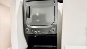 A compact, built-in washer and dryer unit with a control panel and a small storage compartment. - Stylish Heaven/Central SA (San Antonio)