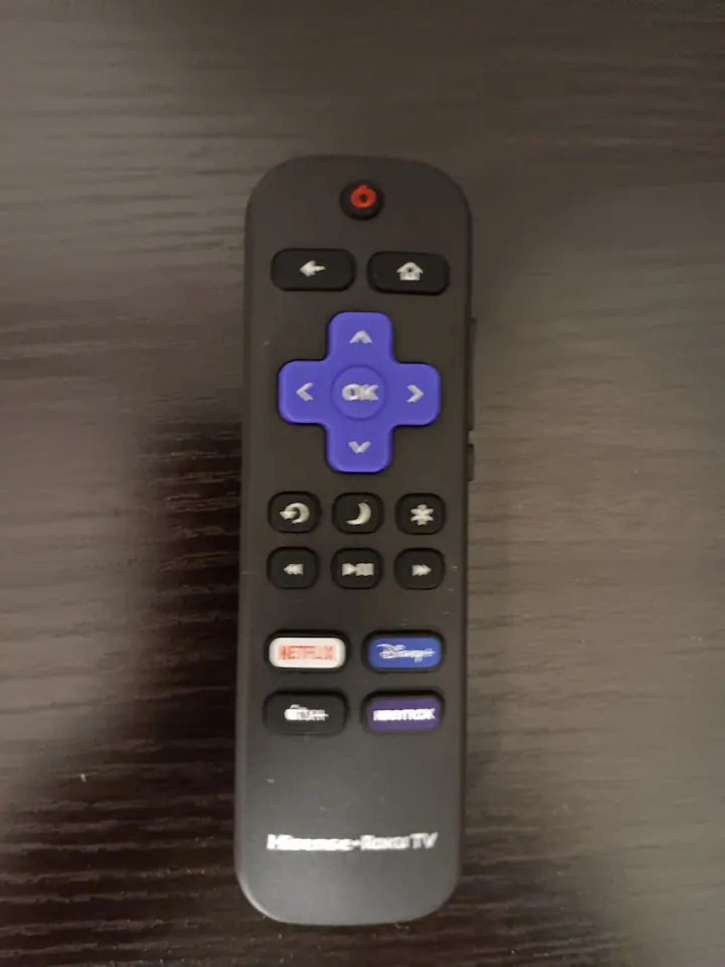 A remote control with directional buttons, an OK button, and buttons for Netflix, Disney+, and HBO.