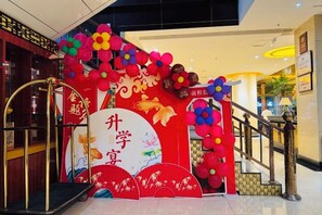 A decorated entrance with a red archway, a large white sign with Chinese characters, and a staircase leading to an upper level. - Jingtai Jingdian Hotel (Jingtai)