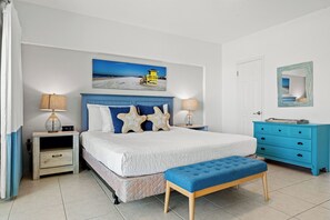 A bedroom with a bed, nightstands, a dresser, and a bench. - Jamaica Royale Beach View Tower by Beachside Management (Siesta Key)