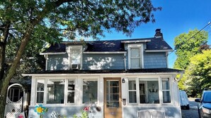 A two-story house with a front porch, a bench, and a mailbox. - 502 Walnut in Lakeside (Lakeside)