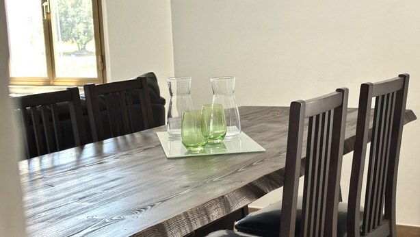 A dining table with four chairs, a glass pitcher, and a glass carafe. - S342 - Sirolo, comfortable three-room apartment near the center (Sirolo)
