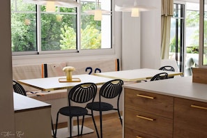 Enjoy cooking in this well-equipped kitchen with an oven, wooden cabinet, and comfortable seating for two.