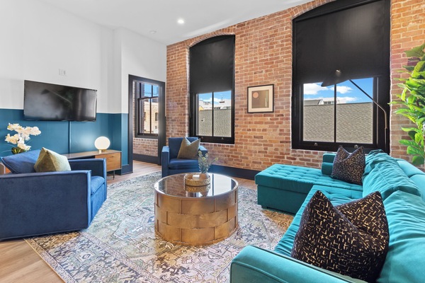 Relax in the living area with a smart TV, stylish seating, and a sleeper sofa for extra guests. Perfect for families or group stays in New Orleans, this inviting space is ideal for movie nights or recharging after a day in the city.