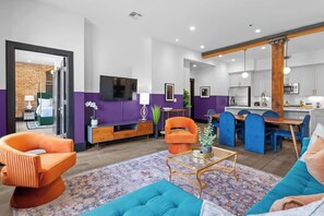 A modern living room with a sofa, armchair, and coffee table.