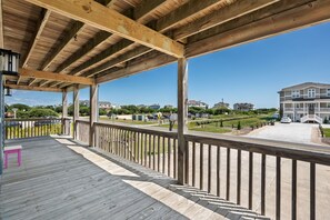 A wooden deck with a bench, overlooking a residential area with houses and a clear sky. - Second Wind: Oceanside with Views, Close to Beach and Lighthouse! (Corolla)