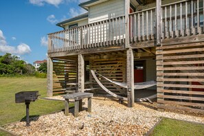 A wooden deck with a hammock, a mailbox, and a bench. - Second Wind: Oceanside with Views, Close to Beach and Lighthouse! (Corolla)