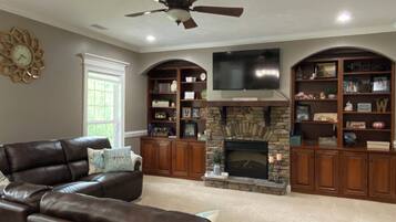 Smart TV, fireplace, books, printers
