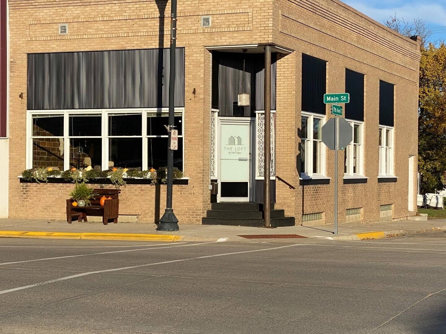 A building with a brick facade, large windows, and a visible entrance.