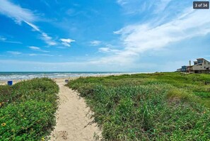 A sandy beach path leading to a house with a view of the ocean. - Welcome to "Coastal Vibes" – your perfect beachside escape! (Galveston)