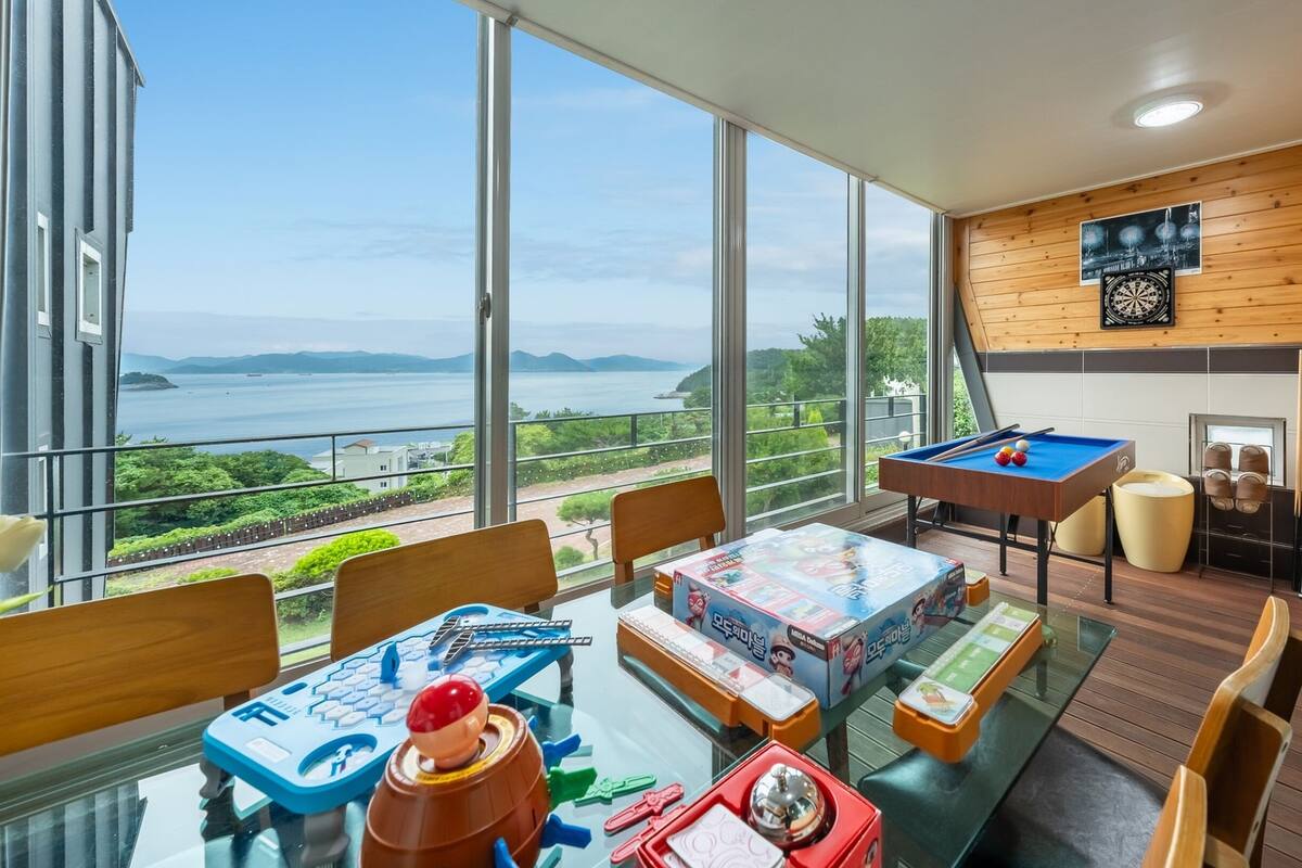 A spacious balcony with a pool table, a ping pong table, and various board games.
