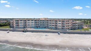 A multi-story hotel with balconies, a swimming pool, and a beach view. - 2 BR Beach Condo, Boutique Resort, 1st Fl Walkout, Steps to Pool & Beach Sleep 6 (Satellite Beach)
