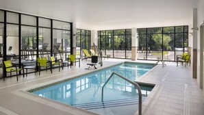 An indoor swimming pool with exercise equipment and chairs, large windows, and a tiled floor. - SpringHill Suites by Marriott Bowling Green (Bowling Green)