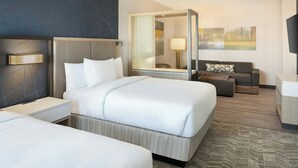 A modern hotel room with a large bed, a sofa, a desk, and a glass-enclosed shower area. - SpringHill Suites by Marriott Bowling Green (Bowling Green)