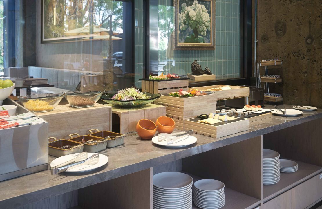 Een buffetopstelling met diverse gerechten en bestek.