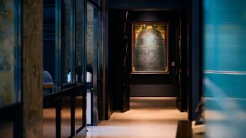 A corridor leading to a room with a large, illuminated artifact.