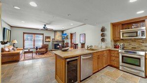 A spacious kitchen with wooden cabinets, a built-in dishwasher, and a stainless steel oven. - 2BR Main St Condo, Walk to Ski Lift! (Park City)