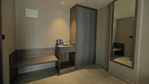 A modern bathroom with a bench, a vanity with a mirror, and a wardrobe. - Mount Land (Sulthan Bathery)