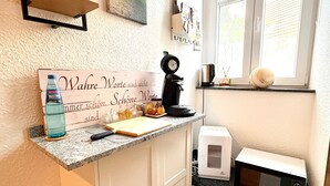 A kitchen with a countertop, a microwave, a toaster, a sink, and a window with a view. - 'Single Room Ahorn, Nature, Wellness' with Private Terrace, Garden, and Wi-Fi (Ottersweier)