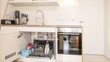 Een koelkast, een oven, een kookplaat, een vaatwasser