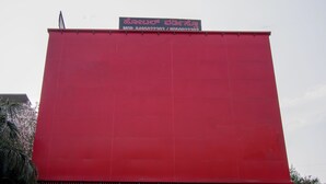 A red building with a sign on top. - Octave Verdisso Hotel (Bengaluru)