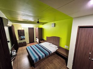 Deluxe Room | Bed sheets - Balaji Resort (Pune)
