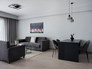 Family Suite, Balcony, City View | Living area | 40-inch Smart TV with cable channels, DVD player - AVA Hotel & Residences Athens Riviera (Kallithea)