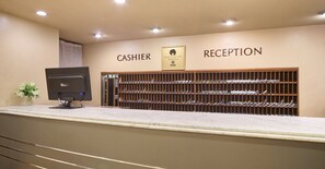 A hotel reception area with a computer monitor, a cash register, and a reception desk. - Hotel Pearl City Morioka (Morioka)