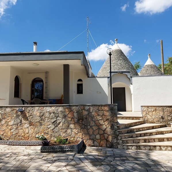 Traditional stone building with a charming entrance and inviting porch.