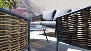 Wicker furniture, a round table, and a cushioned sofa in an outdoor setting. - Vicolo dei Signori By Case al Lago (Desenzano del Garda)