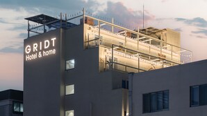 A modern hotel with a prominent sign reading "GRIDT Hotel & home." - Gridt Hotel (Gyeongju)