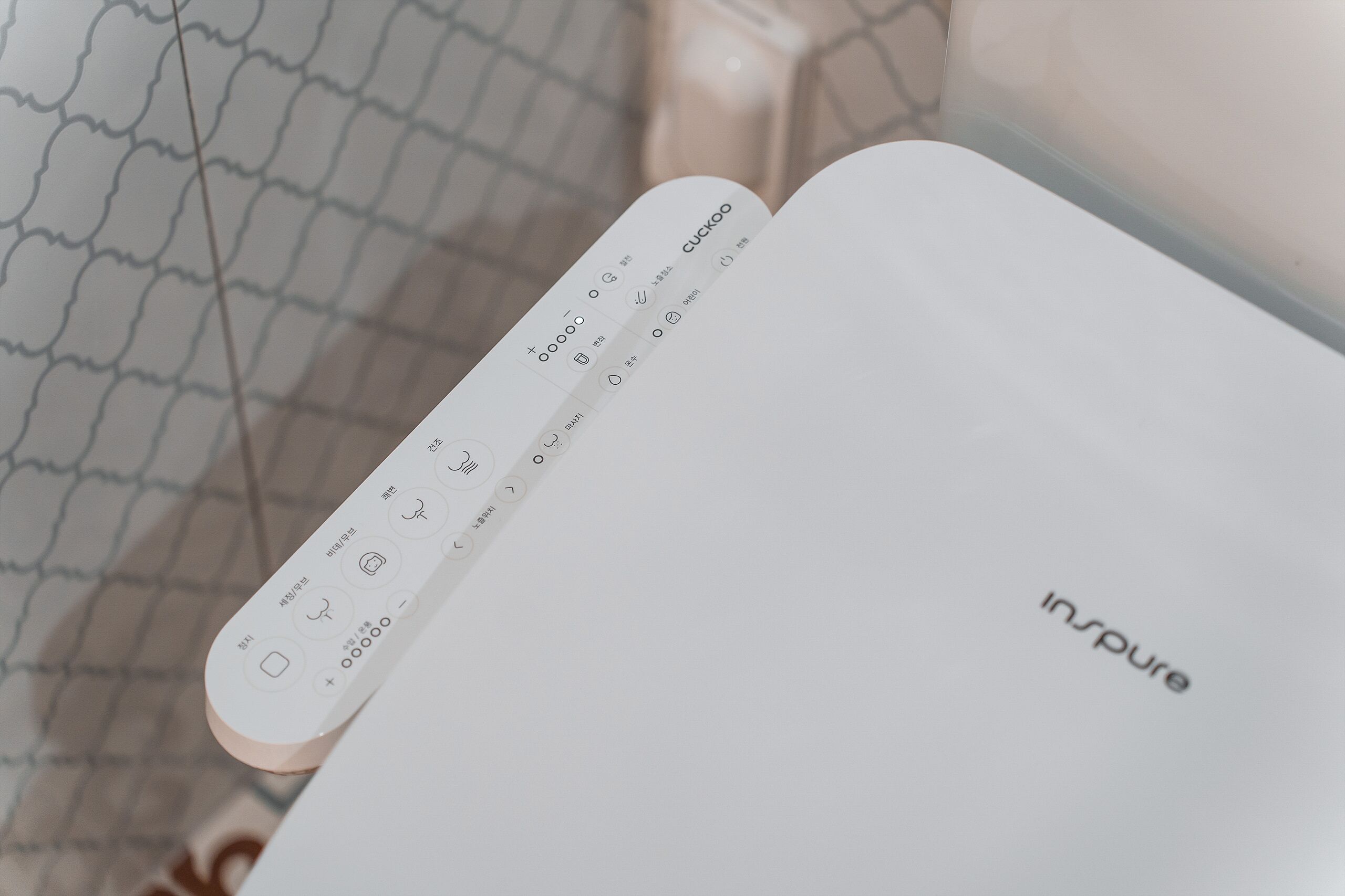 A white electronic device with a control panel and the word "Inspire" on it.