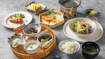 A table set with various dishes including sushi, rice, and soup, suggesting a meal setup.