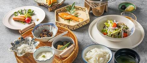 A table set with various dishes including sushi, rice, and soup, suggesting a meal setup.