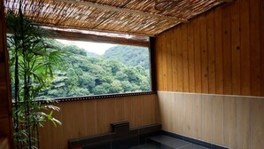 A room with a large window, wooden walls, a tiled floor, and a potted plant. - Hotel Himalaya Sea (Ito)