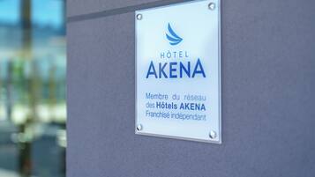 A sign for Hotel Akena, indicating it is part of the Akena Hotel chain and an independent franchise.