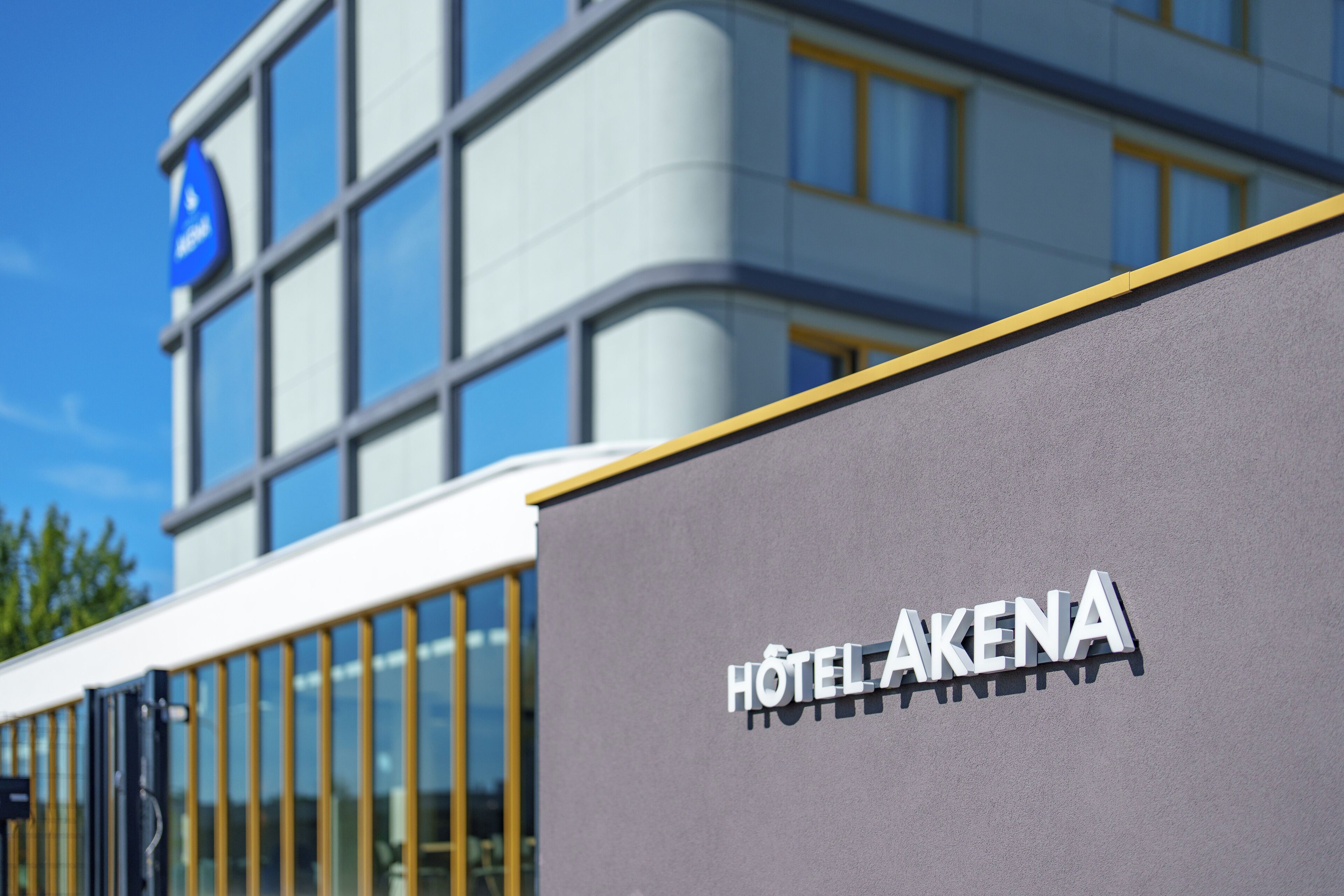 A modern building with a sign reading "HOTEL AKENA".