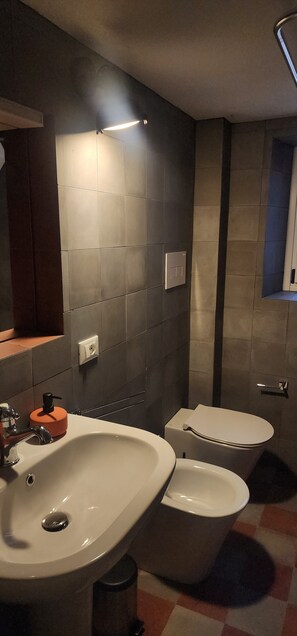 A modern bathroom with a large sink, toilet, and mirror. - Noble palace sky view in the mountains, near the historic center of Erice (Erice)