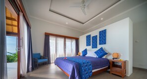 A bedroom with a bed, a chair, a nightstand, and a ceiling fan. - Villa Linggah Longgah, Bali - Spectacular Clifftop Elegance! (Kabupaten Buleleng)