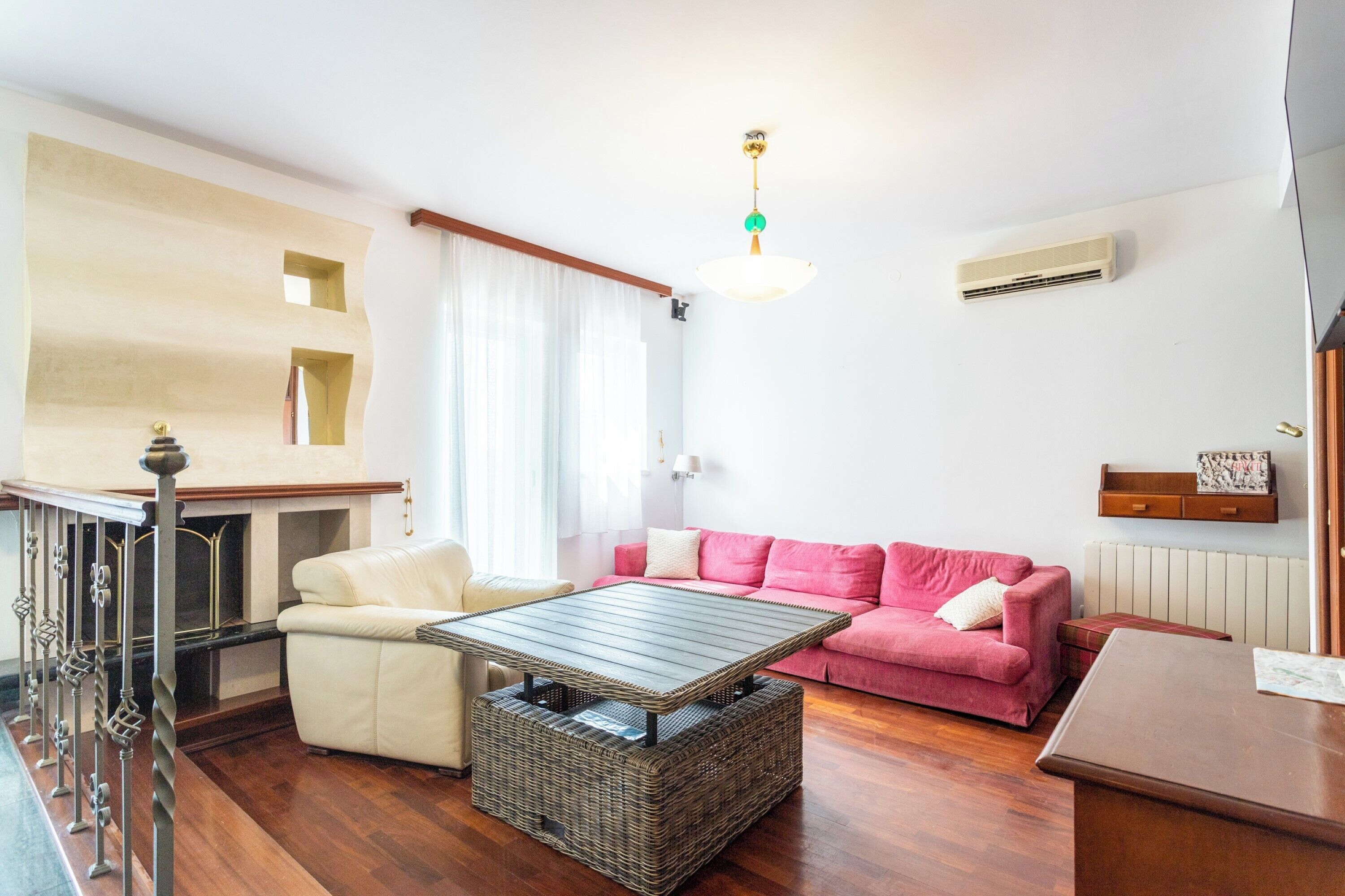 A living room with a sofa, a coffee table, and a dining table.