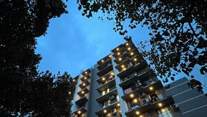 A multi-story building with balconies and air conditioning units, surrounded by trees. - Aleta Residency (Mumbai)