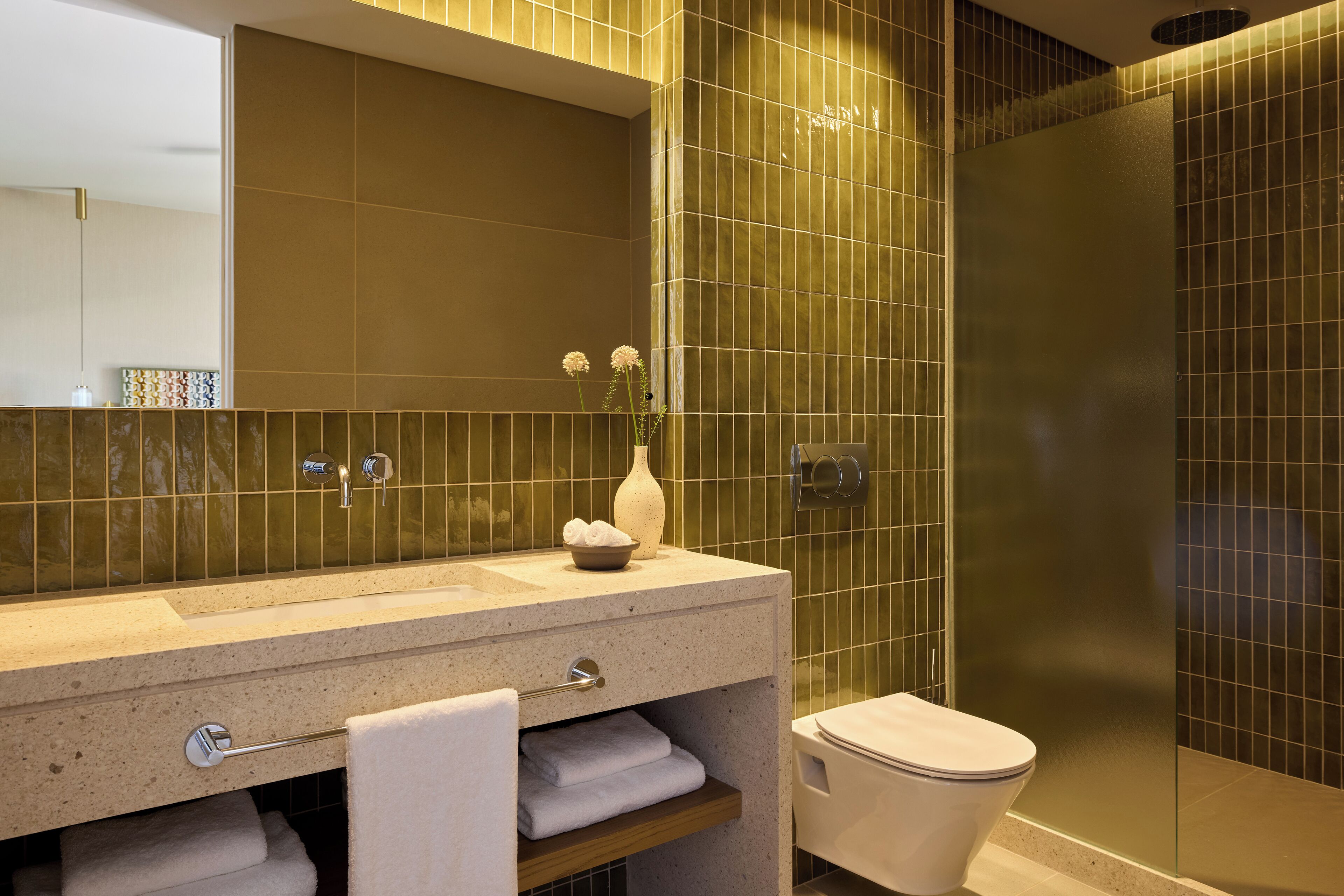 A bathroom with a sink, mirror, towel rack, and toilet.