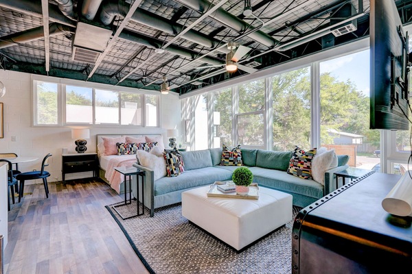 The living room invites relaxation, with plush seating and a peaceful ambiance.