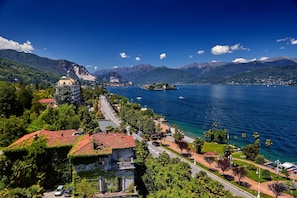 A coastal town with a prominent church, a marina, and a mountain backdrop.