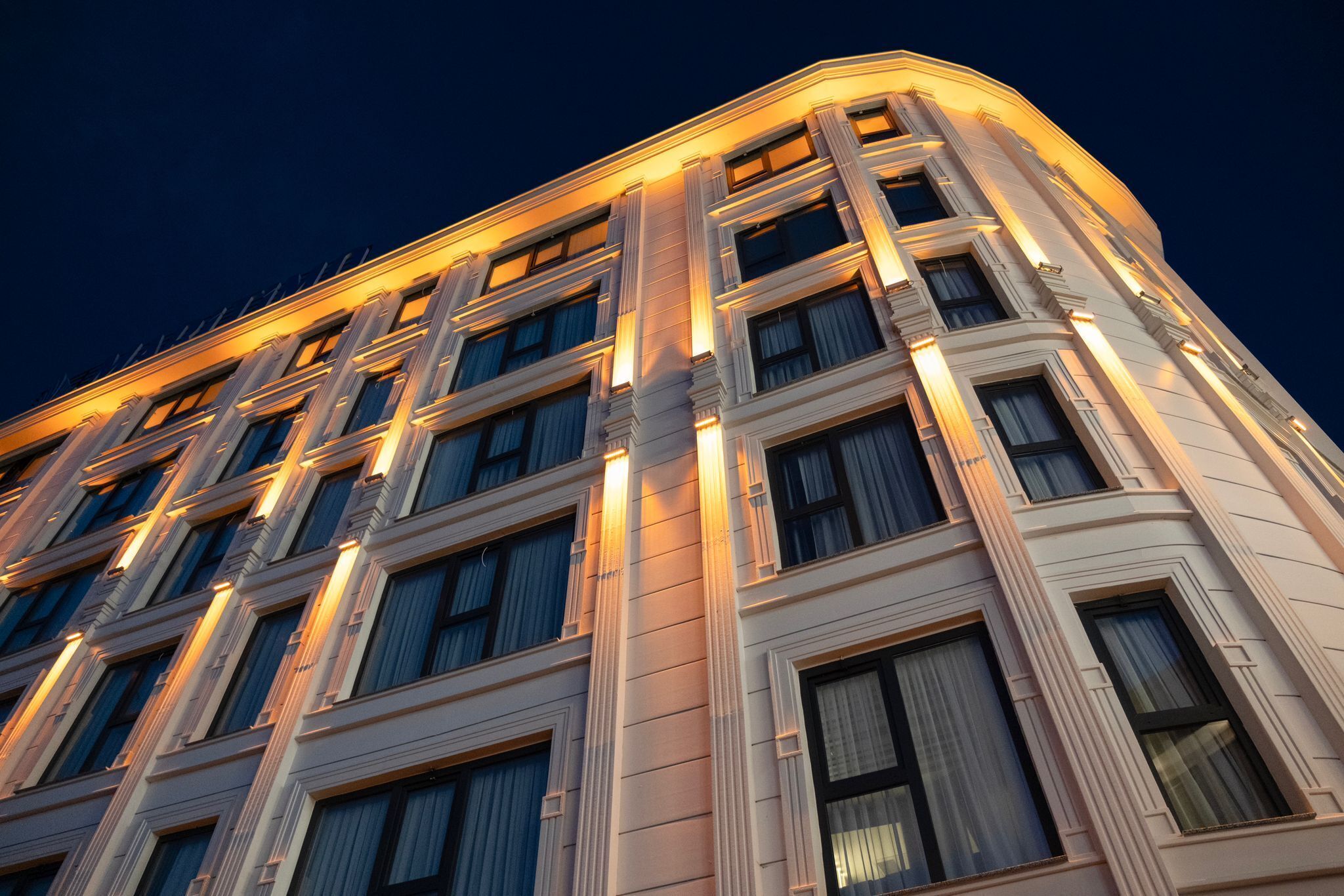 A multi-story building with a classic architectural design, featuring large windows and a symmetrical facade.