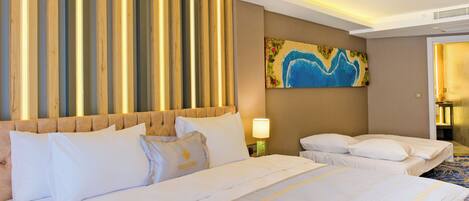 A hotel room with a large bed, a headboard, a painting on the wall, and a lamp.